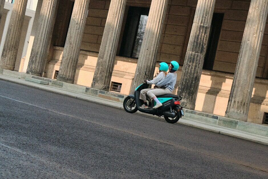 Persons riding a TIER E-Moped on the street